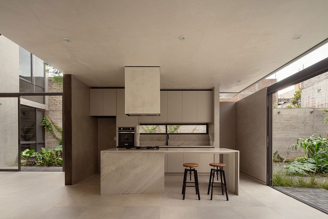 Contemporary kitchen with minimalist design and adjacent garden view.