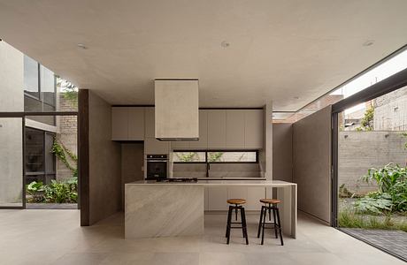 Contemporary kitchen with minimalist design and adjacent garden view.