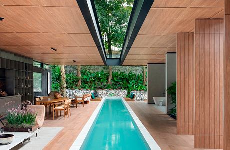 Elegant indoor pool with skylights and wooden ceiling.