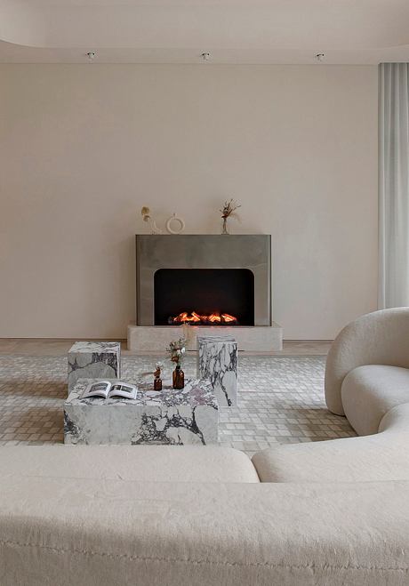 Modern living room with minimalist decor and a lit fireplace.