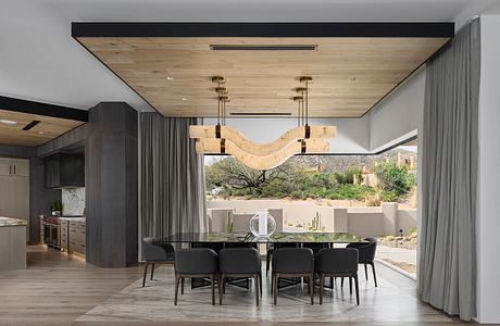 Sleek, contemporary dining area with wooden accents, large windows, and modern lighting.