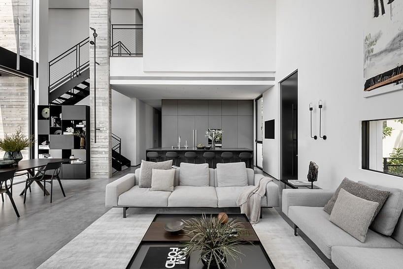 Sleek, minimalist living space with modern furniture, glass walls, and industrial accents.