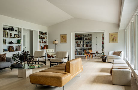 Spacious living room with modern furniture, built-in bookshelves, and natural light.