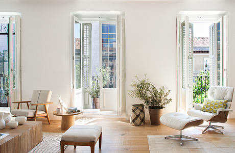 Bright living room with modern furniture and French doors.