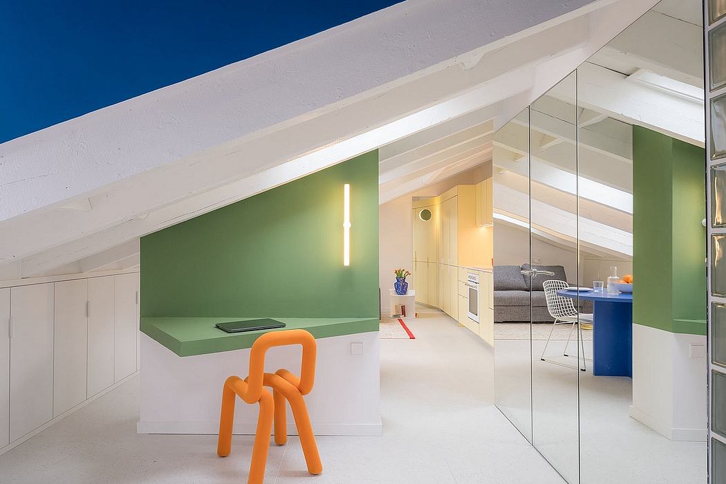 Bright, modern attic space with green accent wall, white floor, and playful orange chair.