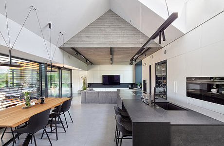 Contemporary kitchen with high ceilings and industrial accents