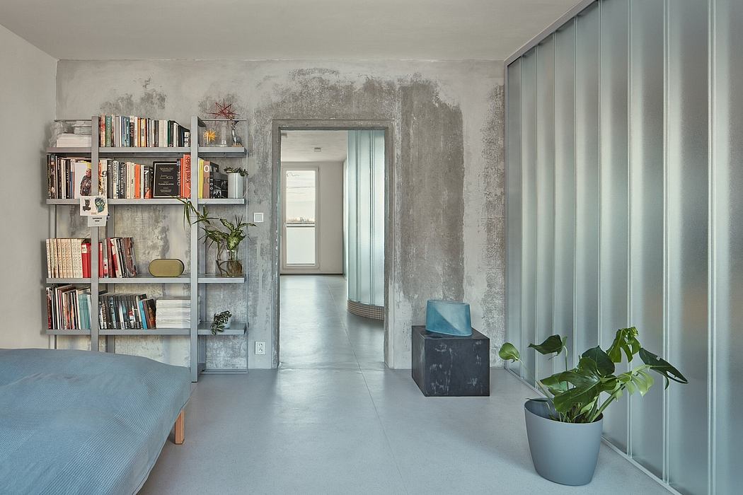 Minimalist living room with industrial-style shelving, potted plants, and concrete walls.