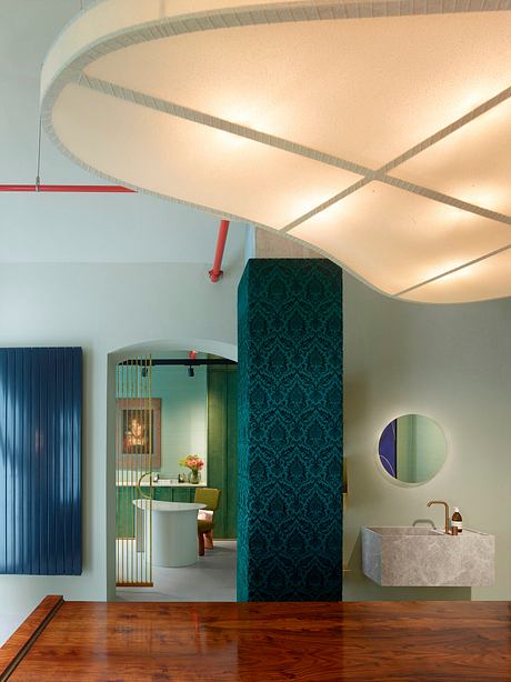 Ornate, angular ceiling with geometric tiled walls, wooden floor, and modern bathroom fixtures.