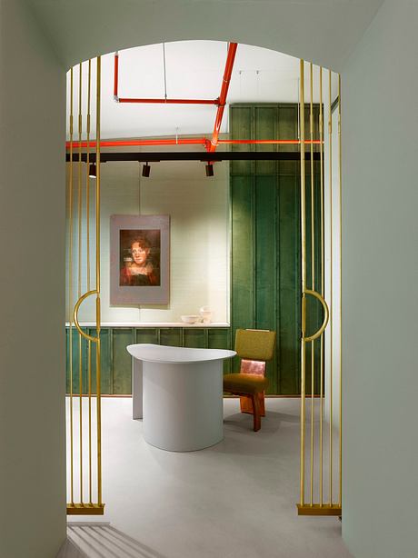 Striking geometric arches with bold red and gold accents, complementing the modern furniture.