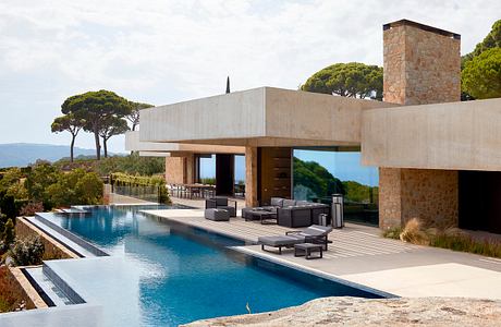 Modern villa with pool, patio, and ocean view.