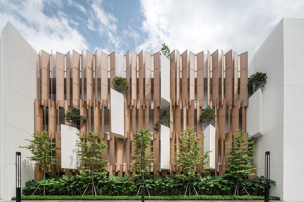 Modern building facade with vertical wooden fins and integrated greenery.