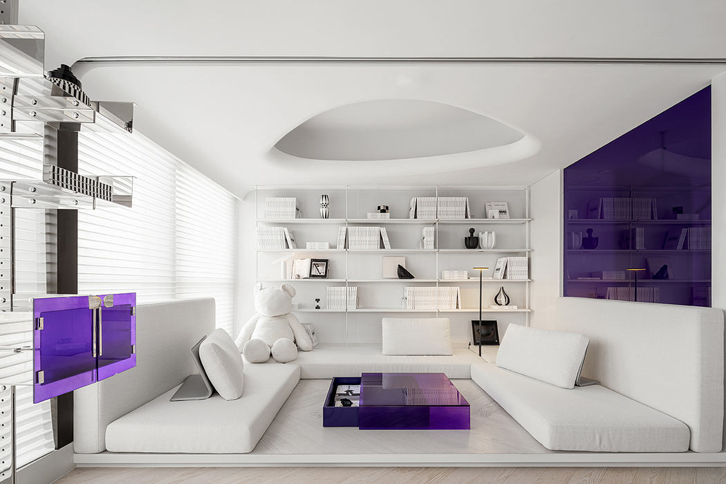 A modern living room with minimalist white furniture, purple accents, and built-in shelving.