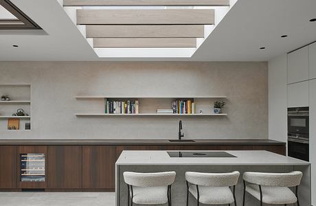 A modern, minimalist kitchen with built-in shelving, wood paneling, and a sleek island.