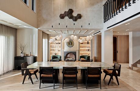 Elegant, modern dining room with geometric light fixtures, marble table, and plush seating.