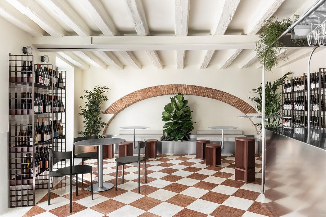 Spacious, modern interior with white beams, exposed arched brick, and a checkered tile floor.
