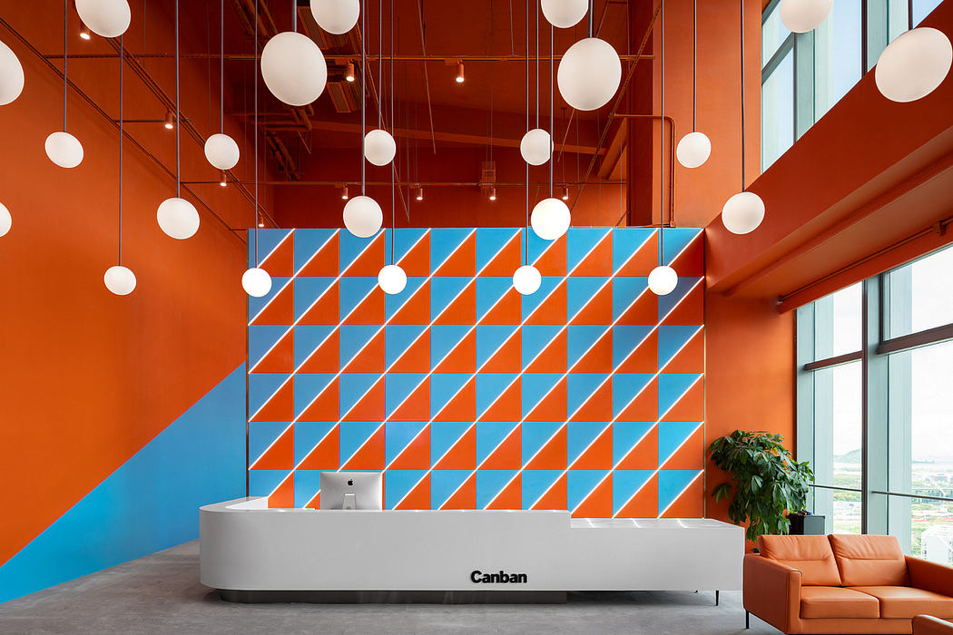 Vibrant, geometric patterns create a dynamic, modern office reception area.