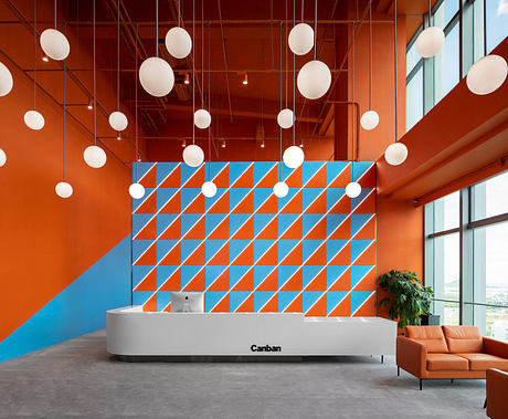 Vibrant, geometric patterns create a dynamic, modern office reception area.