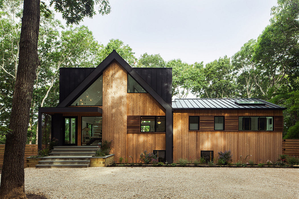 A modern, rustic cabin with a combination of wood, metal, and glass elements.