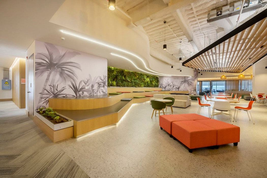 Bright, modern office space with tropical-inspired murals, wooden beams, and vibrant furniture.