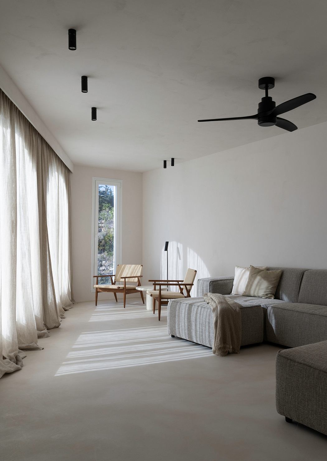 A minimalist living room with sleek, modern furniture and mood lighting.