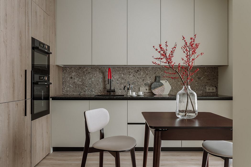 Minimalist kitchen with wooden cabinets, granite countertop, and decorative red branches.