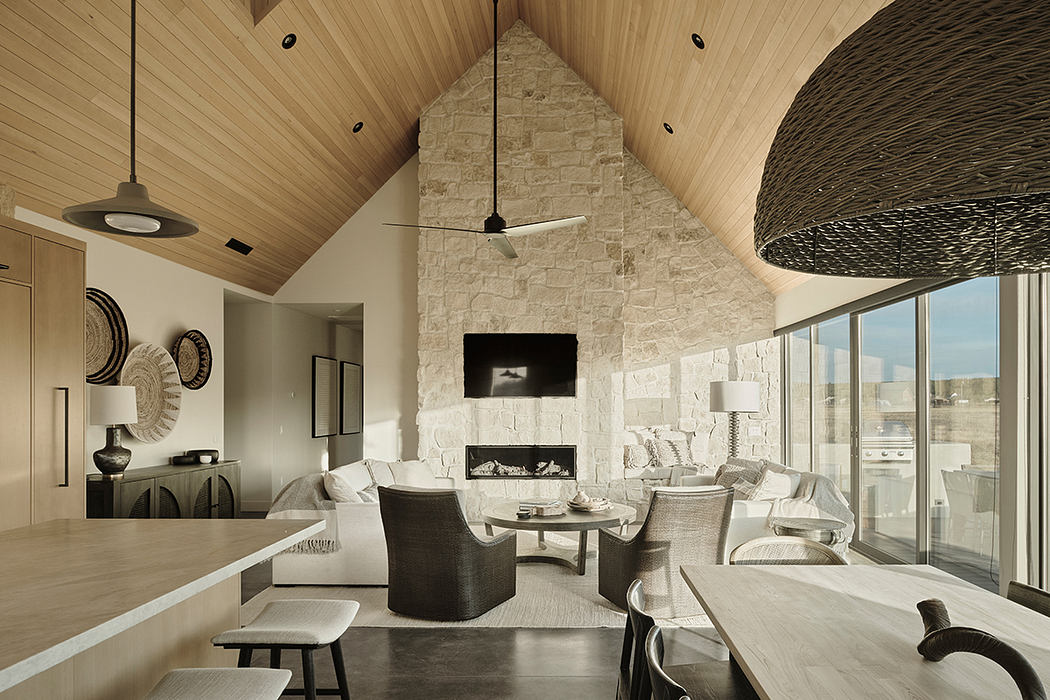 Striking vaulted wooden ceiling, stone fireplace, and modern furnishings in this spacious room.