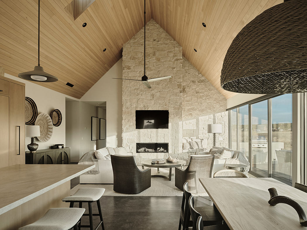 Striking vaulted wooden ceiling, stone fireplace, and modern furnishings in this spacious room.