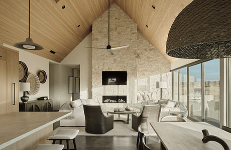 Striking vaulted wooden ceiling, stone fireplace, and modern furnishings in this spacious room.