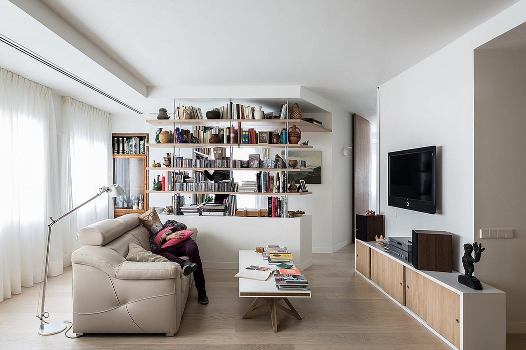 Cozy living room with built-in bookshelves, wooden TV stand, and minimal decor.