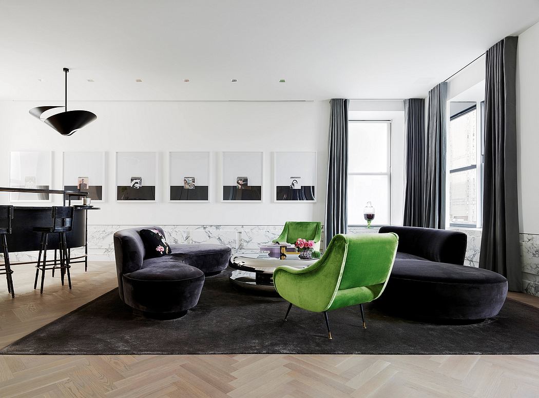 Sleek, modern living space with plush velvet seating, marble accents, and framed artwork.