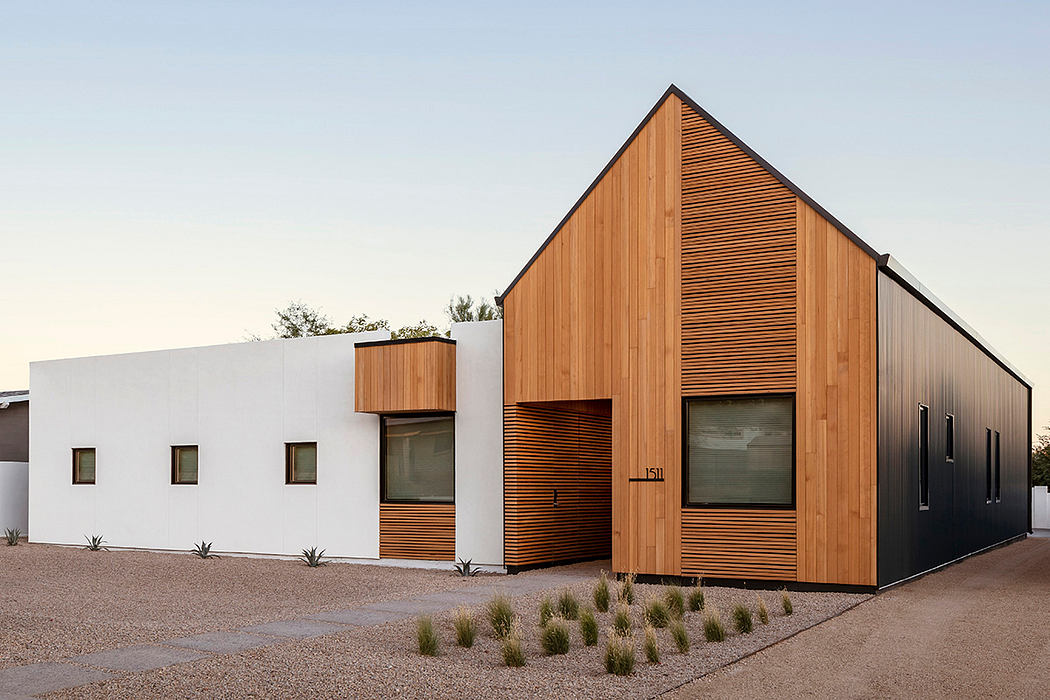 Minimalist architecture with a mix of wood paneling and white walls, featuring clean lines.