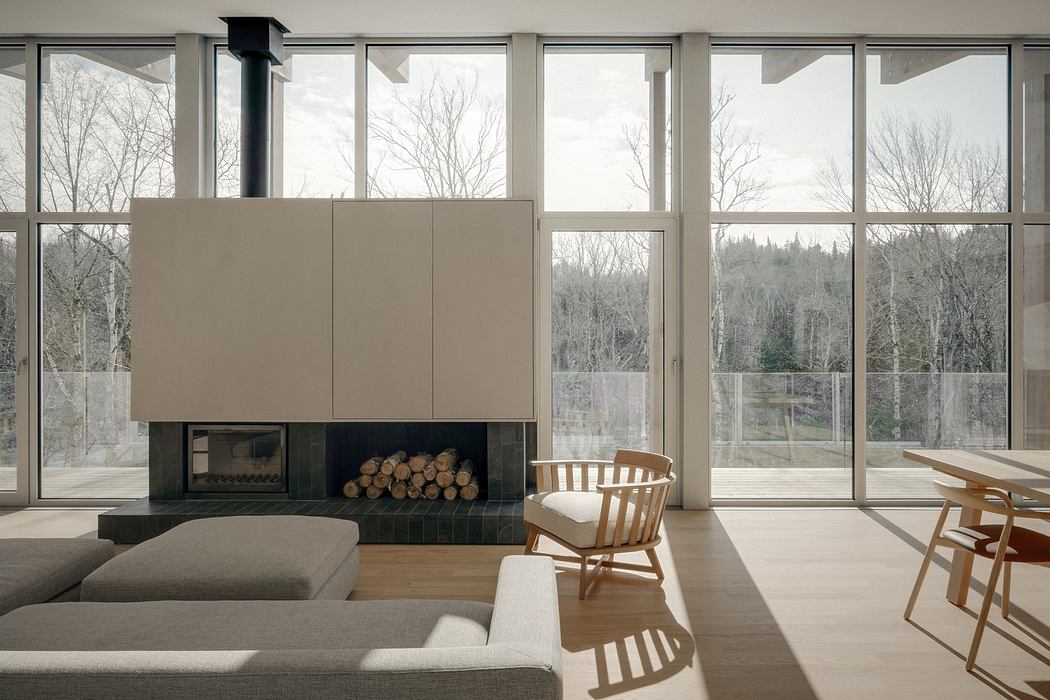 Spacious living room with large windows, sleek fireplace, and minimalist furniture.
