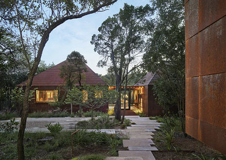 A modern, nature-inspired home with striking roofs, wooden exteriors, and a tranquil garden path.