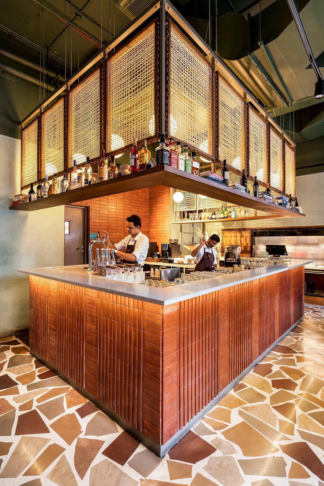 Rustic yet modern bar with wooden screens, sleek counters, and creative tile flooring.
