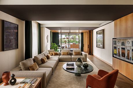 A modern, open-concept living room with wooden accents, plush seating, and a sleek glass coffee table.