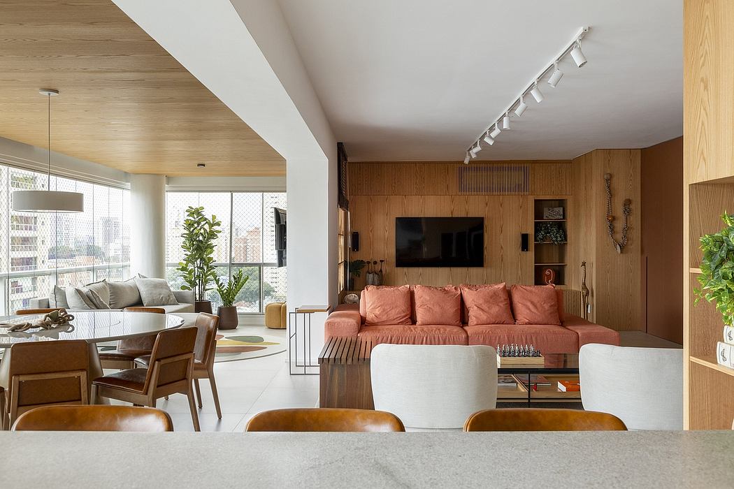 Cozy living space featuring warm wood accents, large sofa, and track lighting.