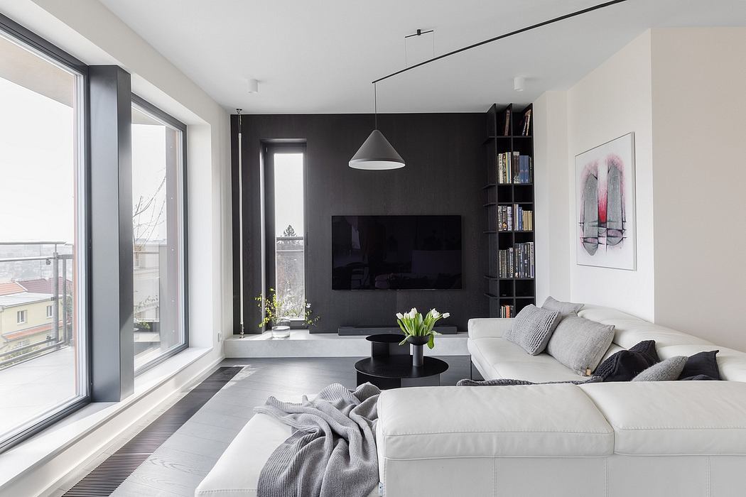 Sleek, modern living room with dark accent walls, built-in shelves, and large windows.