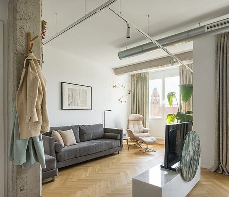 Bright, open-concept living space with industrial-style lighting and natural materials.