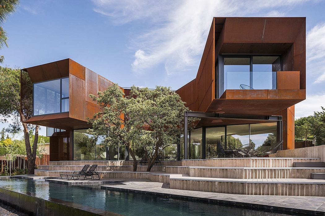 Striking modern architecture with copper-colored panels, glass walls, and multi-level design.