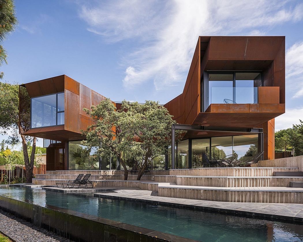 Striking modern architecture with copper-colored panels, glass walls, and multi-level design.
