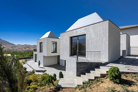 Striking modern architecture with clean lines, textured facade, and elevated terraces.