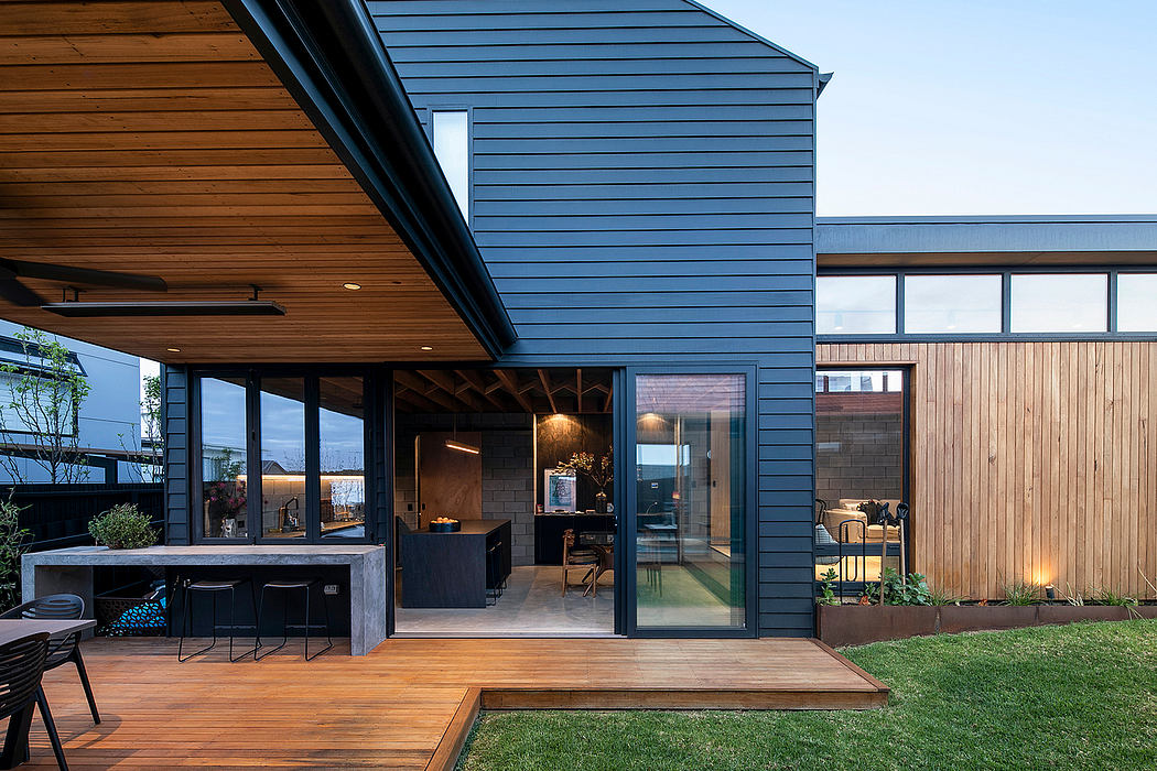 Contemporary wooden patio with glass walls, integrated outdoor area, and landscaped yard.