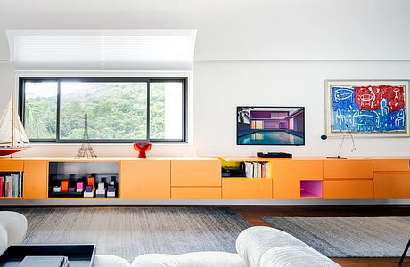 Vibrant modern living space with colorful built-in storage and artwork accents.