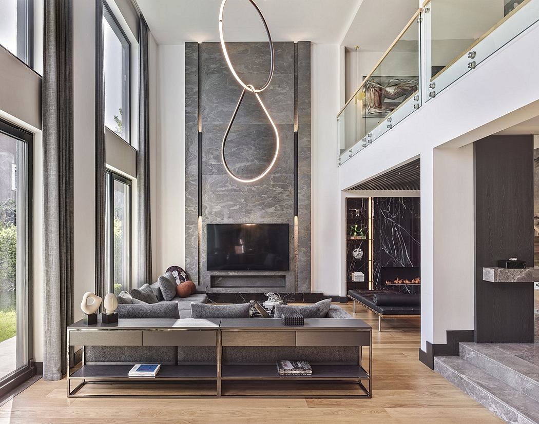 A modern living room with a sleek fireplace, curved lighting fixture, and minimalist furnishings.