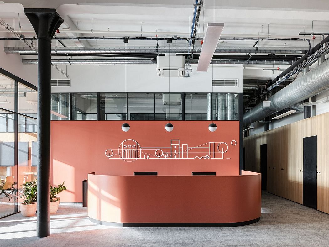 Modern industrial-style office lobby with a curved orange reception desk and a skyline-inspired graphic wall.