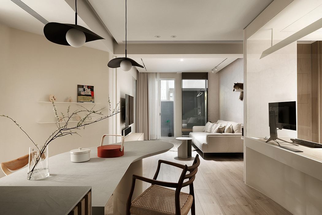 Modern, minimalist living room with sleek furniture, pendant lights, and wood floors.