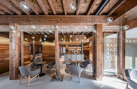 Rustic wooden beams, glass chandeliers, and plush seating in a modern lounge.