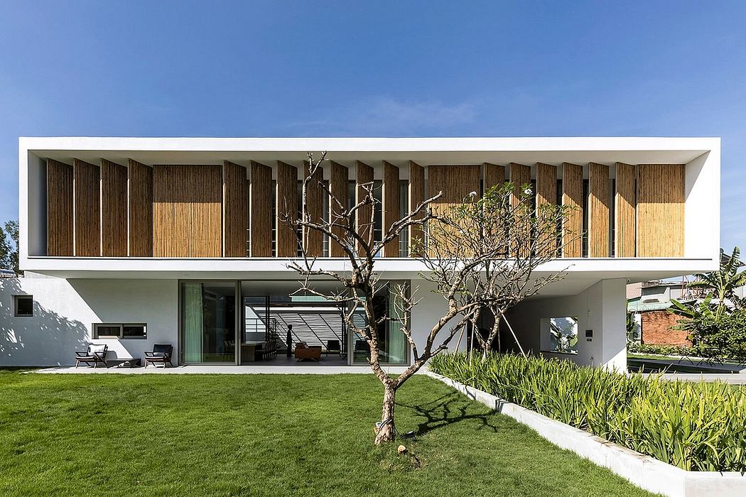 Minimalist architectural design with wooden facade, large glass windows, and lush landscaping.