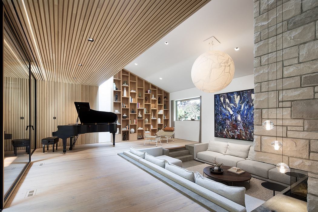 Spacious living room with tall wooden ceiling, custom bookshelf, piano, and modern art.
