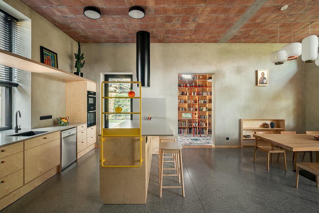 A modern kitchen with a yellow storage unit, wood-paneled ceiling, and open layout.